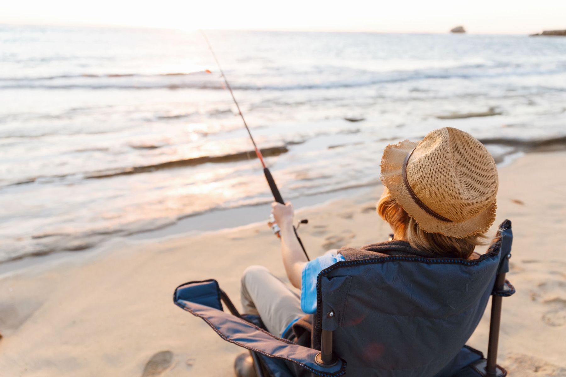 Teenage boy fishing at sea